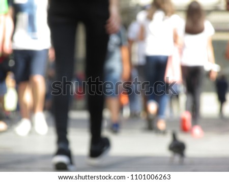 Blured people on the street. Foot, legs of people 
