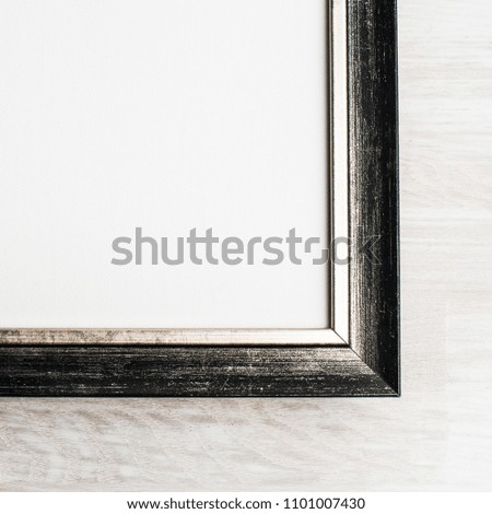Classic golden painting canvas frame isolated on wooden background