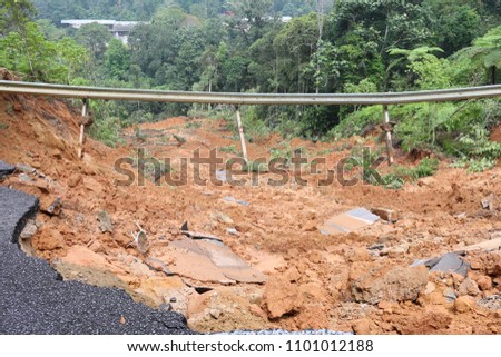 Road damage caused by landslides. Royalty-Free Stock Photo #1101012188