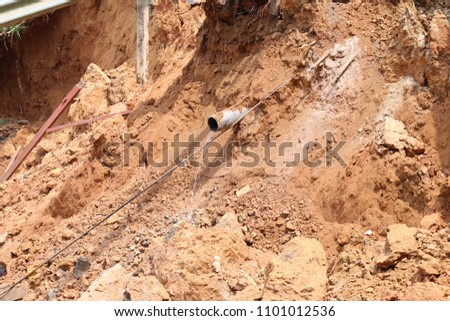 The occurrence of landslides is caused by leaking waterways pipe. Royalty-Free Stock Photo #1101012536