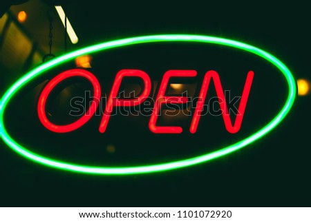 neon sign "Open" at night, round the clock work, advertising business restaurant