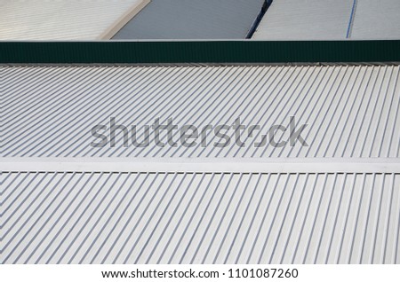 Metal gray roof with rhythmic parallel relief directions