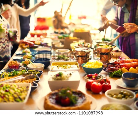 Diverse people at an international dinner buffet Royalty-Free Stock Photo #1101087998