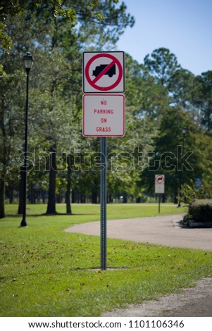 Traffic sign prohibiting the parking on the grass in the park. Nature. Road sign in the rest area. Rules for travelers.