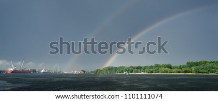 RAINBOW - Picture of a sea port after a downpour