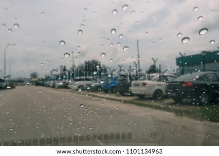 Driving in rain. Rainy weather through the car window. 