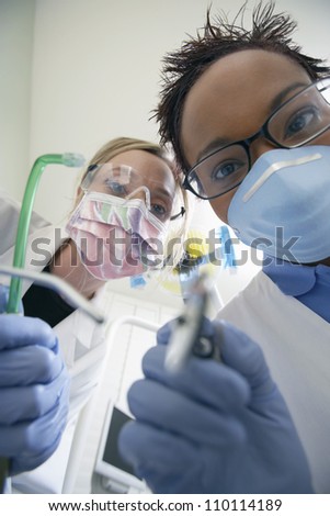 Portrait of two female dentists with dentistry equipments