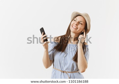 Young charming woman in dress, hat listening music in earphones on mobile phone, enjoy, relax, isolated on white background. People, sincere emotions, lifestyle concept. Advertising area. Copy space
