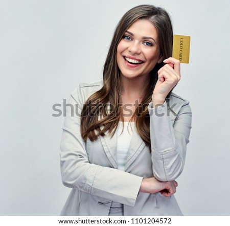 Smiling business woman holding gold credit card. Businesswoman in business suit isolated studio portrait.
