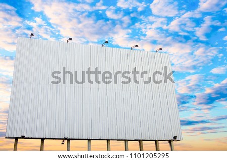 Big Black billboard on the blue sky background. Clean blank sign and cloud on the sky. Billboard for advertisement.Copy space.