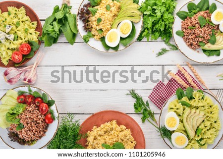 A set of food from buckwheat, bulgur and pasta. On a wooden background. Top view. Copy space.