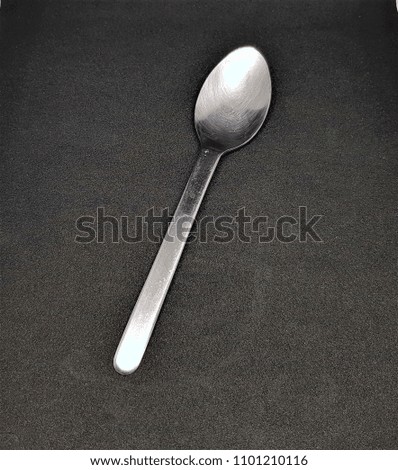 



The spoon rests on a black background
