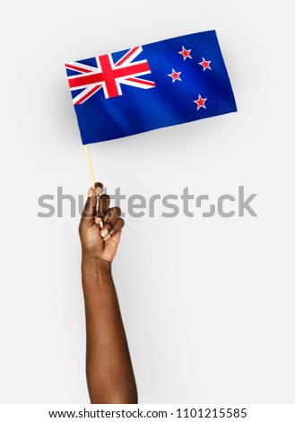 Person waving the flag of New Zealand