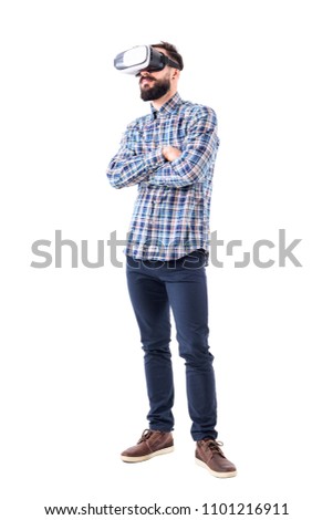 Bearded adult business man watching virtual reality glasses with crossed arms. Full body isolated on white background.