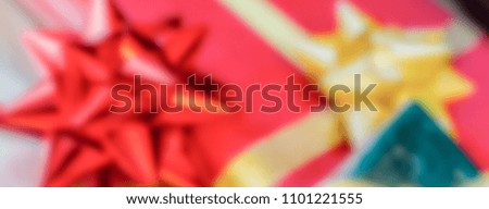 Defocused background of Christmas gifts with red packages. Intentionally blurred post production for bokeh effect