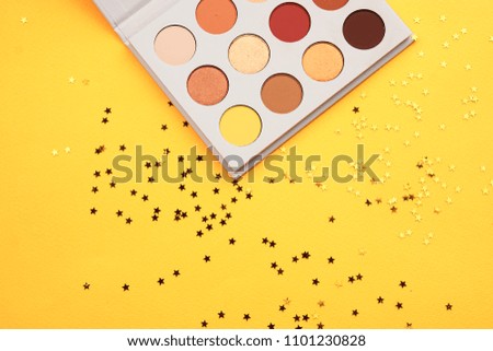 Multi-colored eye shadow on a yellow background                      