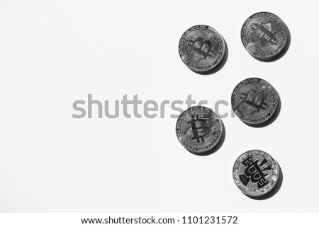 top view of arranged silver bitcoins on white backdrop