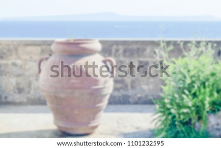Defocused background of Terracotta Vase against a Mediterranean Panorama. Intentionally blurred post production for bokeh effect