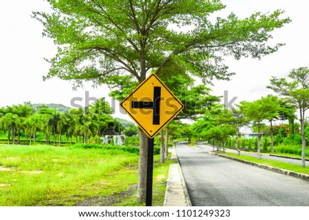 a road sign beside a road in countryside of Thailand 