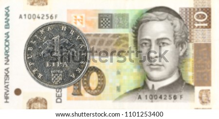 2 croatian lipa coin against 10 croatian kuna bank note