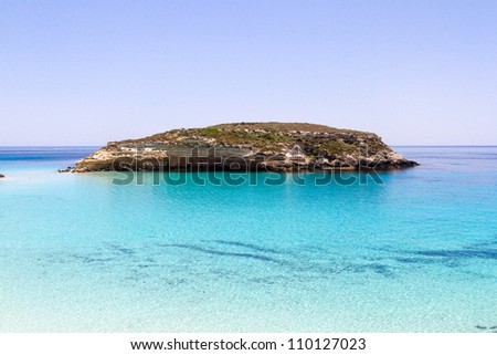 Pure crystalline water surface around an island (Lampedusa) Royalty-Free Stock Photo #110127023