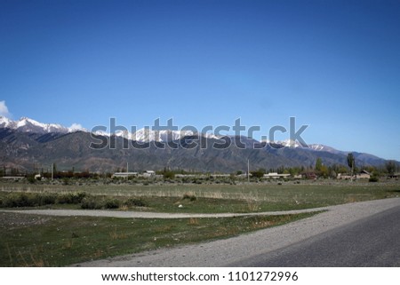 Scenic road view of Tian Shan mountain range near Northern shore of Issyk-Kul Lake, Kyrgyzstan