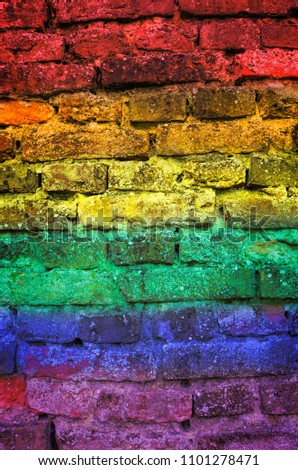 Rainbow flag painted on old brick wall texture background