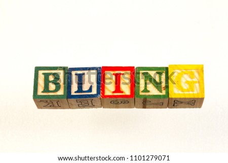 The term bling visually displayed on a white background using colorful wooden toy blocks image with copy space in landscape format