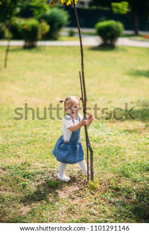 Happy child walks in the park in summer