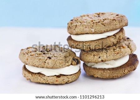 Carrot cake raisin cookies sandwiches stuffed with cream cheese icing. Room for copy text.