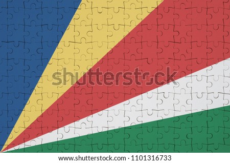 Seychelles flag  is depicted on a folded puzzle