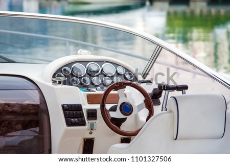 Pleasure boat. White tone. Steering wheel Royalty-Free Stock Photo #1101327506