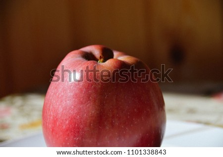 Big ripe red apple on table on wooden background