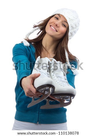 Young woman showing ice skates for winter  ice skating sport activity in white hat smiling isolated on a white background