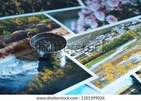 Compass on blur colorful photograph of popular tourist destination background, China traveling concept