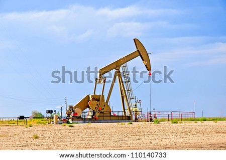 Large pump jack pumping crude oil up to the surface.