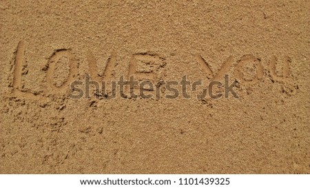 Write on the sand that love you, it can be used as a background image.
