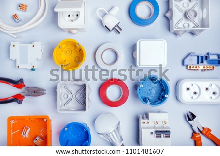 Different electrical tools on light grey background with plase for text, top view. Royalty-Free Stock Photo #1101481607