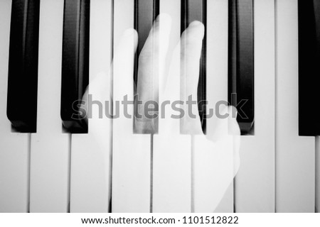 Close of hands plays melody on piano. Mobile photo