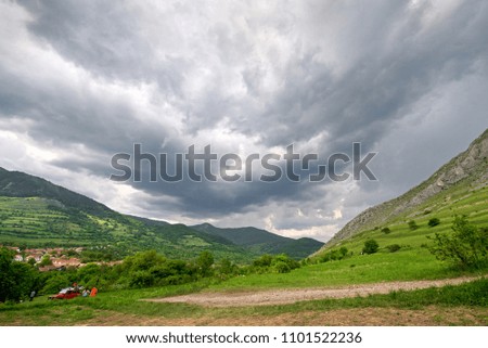 Early morning thunder storm clouds  over a mountain peak, where tourists climb to conquer fear, find courage and develop lateral thinking skills to overcome the difficulty of climbing a mountain.