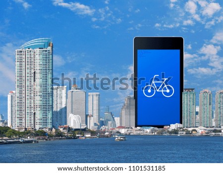 Bicycle flat icon on modern smart phone screen over office city tower, river and blue sky, Bicycle shop online concept