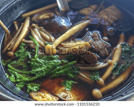 Buk Kut Teh, a Chinese pork soup dish, eat with rice and some vegetable