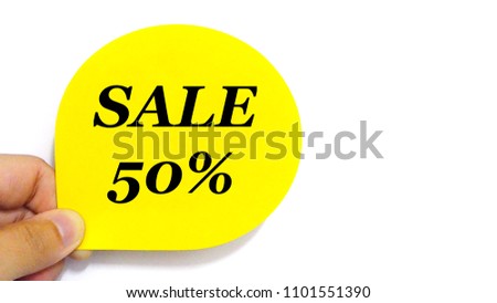 Hand holding SALE 50% off on yellow tag for shops. Shopping, discount, sales promotions, marketing concept