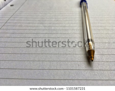 A blue writing pen against a lined paper background. There’s a beginning to everything.