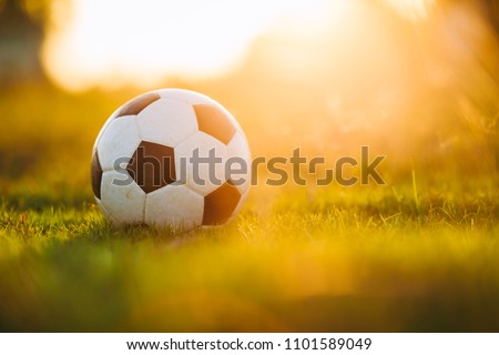 A ball for street soccer football under the sunset ray light. Concept for sport and exercise for kids.Picture with copy space.