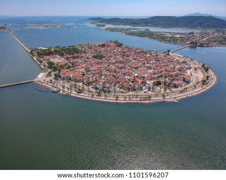Aerial scenic view of the famous island - town of Aitoliko in Aetolia - Akarnania, Greece is situated in the middle of Messolonghi Lagoon and it is known as the Little Venice of Greece. Royalty-Free Stock Photo #1101596207