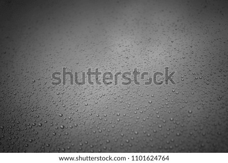 photo of rain drops on the window glass, with cloudy sky as background