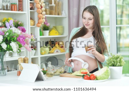 beautiful pregnant woman with headphones