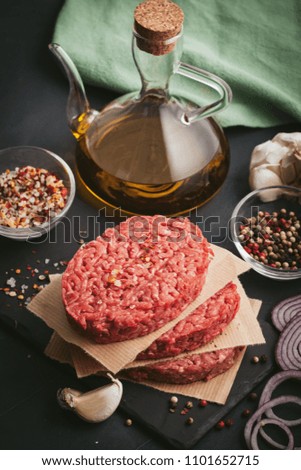 Homemade raw organic minced beef meat burger steak on a slate board. Healthy food, cooking blog, classes concept. Copy space background, top view