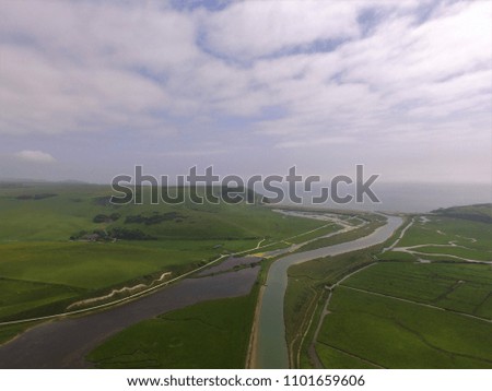 High aerial still image of the River Cuckmere in East Sussex England.